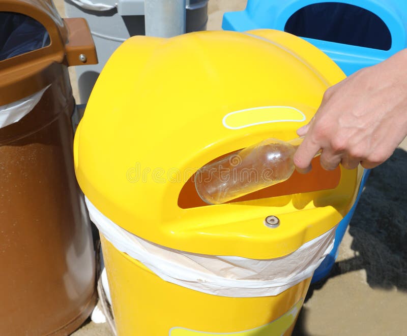 Hand Throwing Away a Used Glass Bottle in the Waste Bin for Sepa Stock