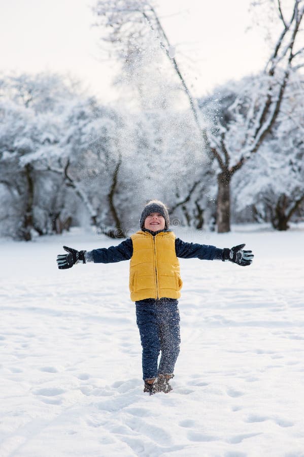 Boy Throws Up Snow and Spreads His Arms To Sides Stock Image - Image of ...