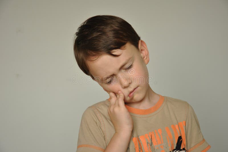 A boy with a toothache stock photography