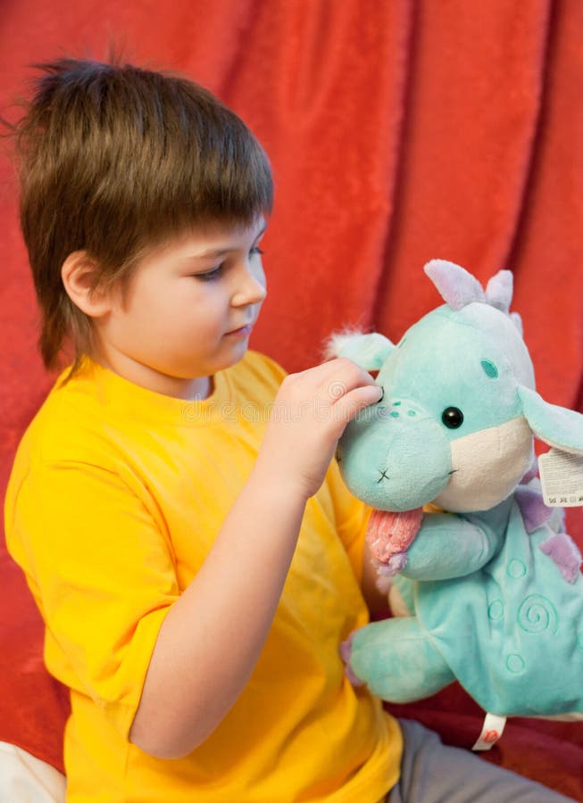 Boy with toy dragon - symbol of the new year