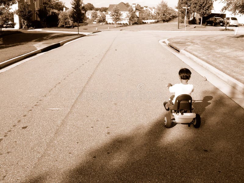 Boy riding tricycle. Boy riding tricycle