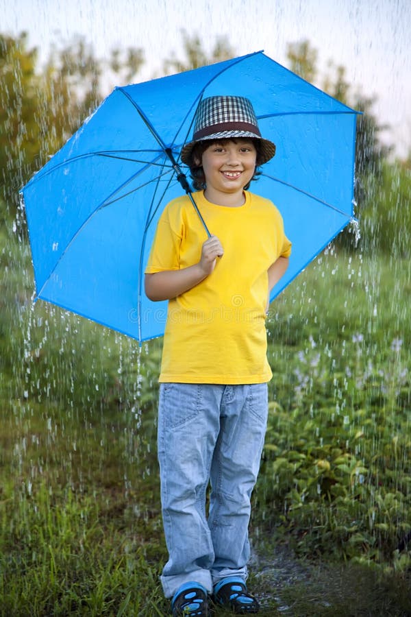 Boy with umbrella outdoors stock image. Image of happiness 76899919