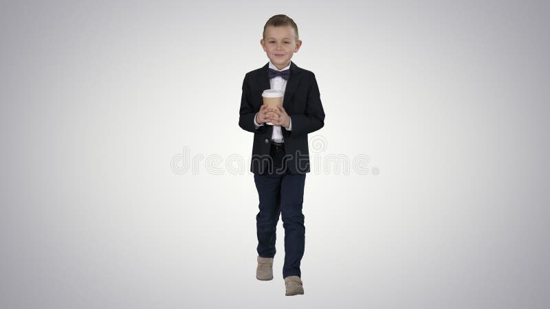 Boy walking with a take away coffee in a formal clothes on gradient background.