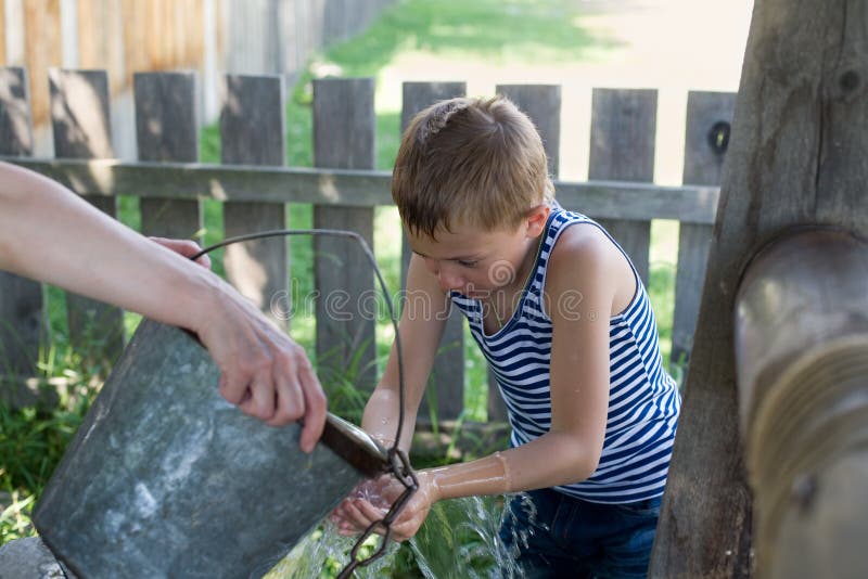 Boy washes well water.