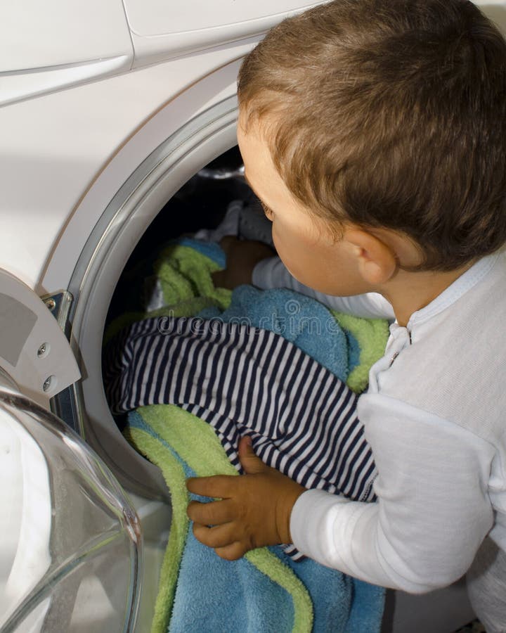 Boy at the washing machine royalty free stock photo