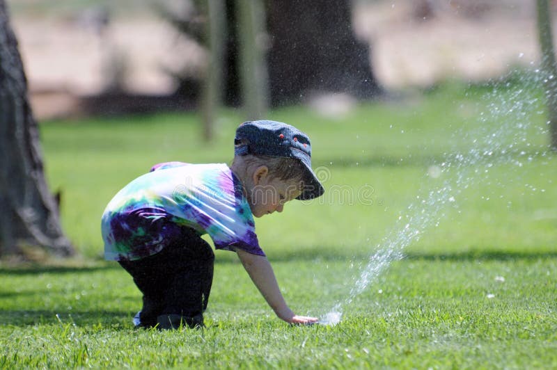 Boy at water sprinkler