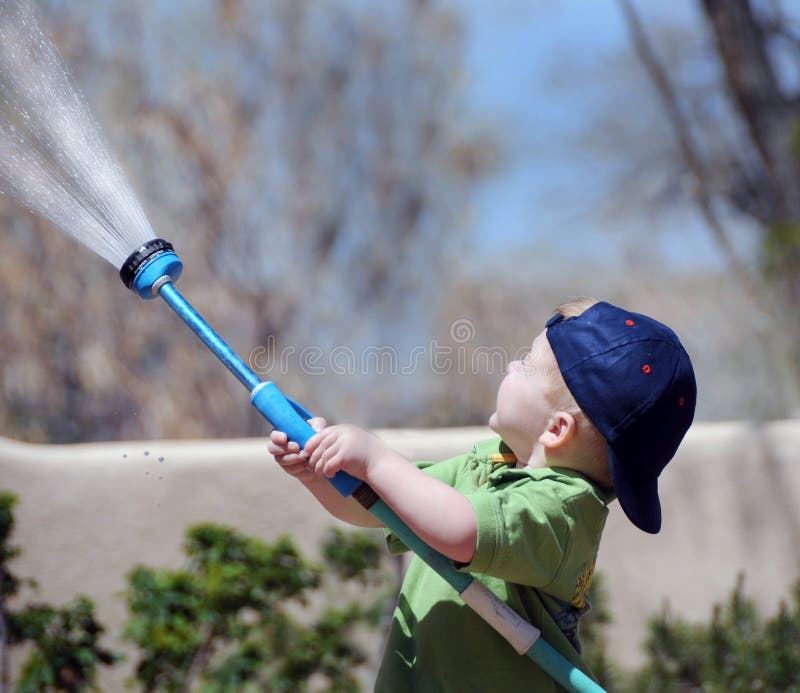 Boy watering the garden