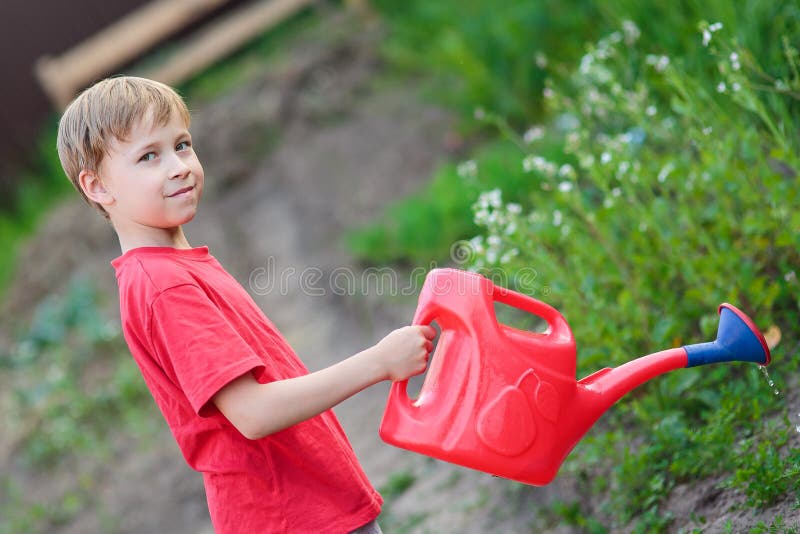 Boy watering garden