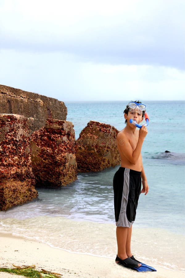 Boy wearing snorkeling goggles and flippers stock images