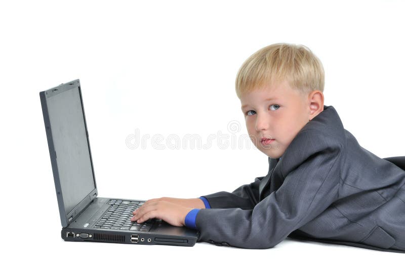 Boy wearing suit working on laptop royalty free stock photo