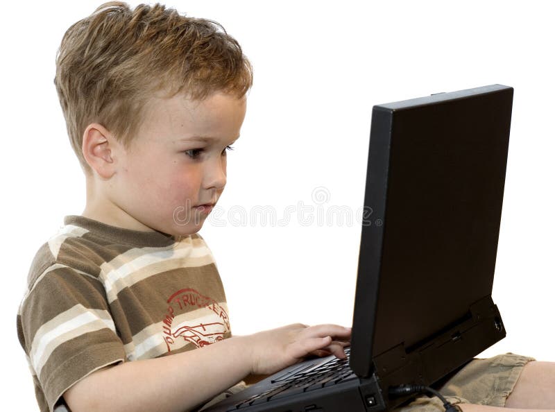 Five year old boy working on a laptop computer.