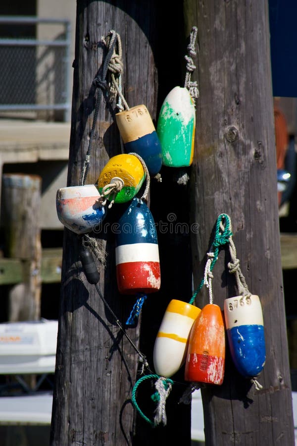 Collection of colorful buoys hanging from poles in south portland maine. Collection of colorful buoys hanging from poles in south portland maine