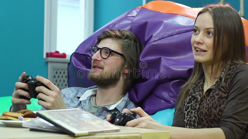 Boyfriend learning his girlfriend to play video games on