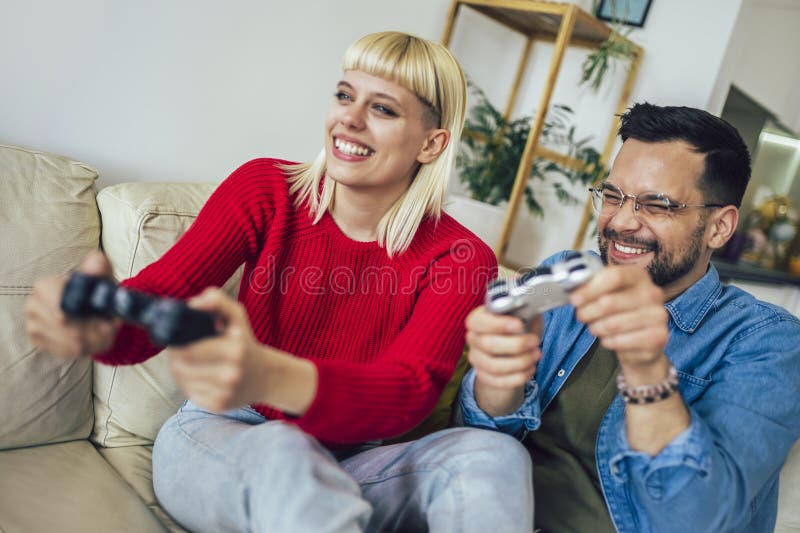 Young Cute Competitive Boyfriend Girlfriend Playing Video Games In Couch  Stock Photo, Picture and Royalty Free Image. Image 34313215.