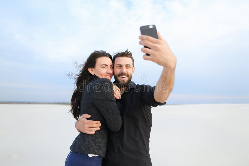 Free Photo | Cute woman posing with peace sign while her boyfriend in  orange sweater making selfie