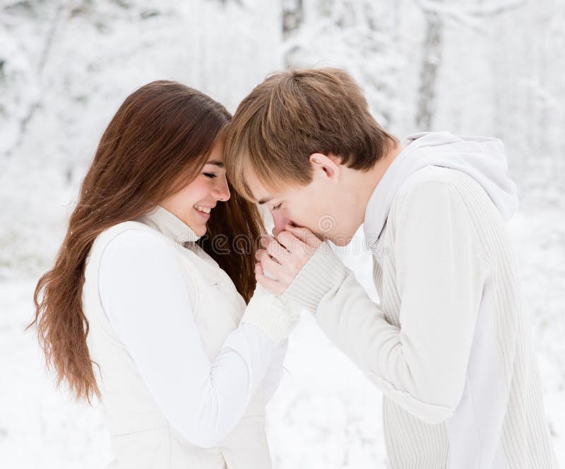 Boyfriend warms hands sweetheart, frozen in the cold royalty free stock photo Boyfriend warms hands sweetheart, frozen in the cold royalty free stock photo