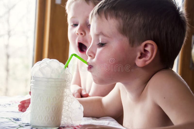 boys blowing milk bubbles