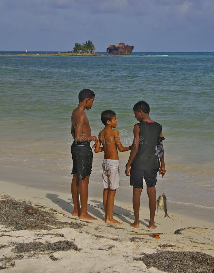 Boys with fish at San Andres beach, Colombia stock photography Boys with fish at San Andres beach, Colombia stock photography