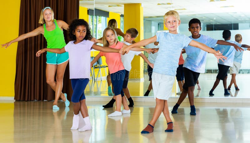 Boys and Girls Dancing Rock-and-roll in Pairs with Female Trainer Stock ...