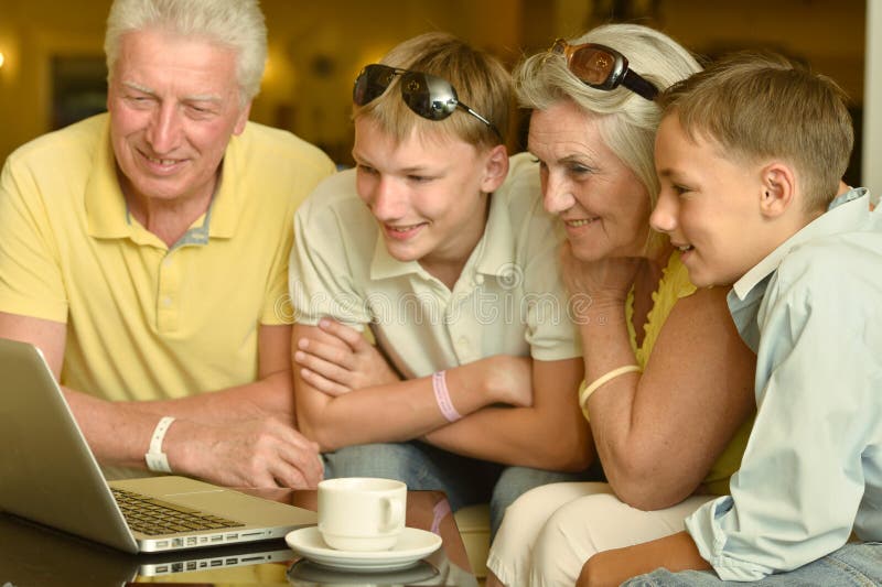 Boys with grandparents and laptop