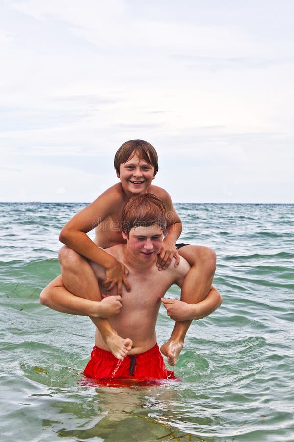 Boys having fun in the beautiful clear sea