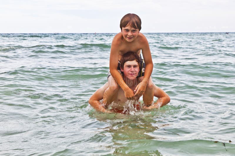 Boys having fun in the beautiful clear sea