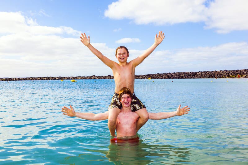 Boys having fun in the clear sea