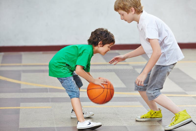 Boys playing basketball in school stock image Boys playing basketball in school stock image