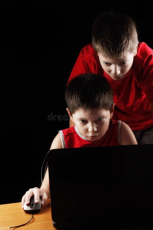 Boys playing computer game stock photography