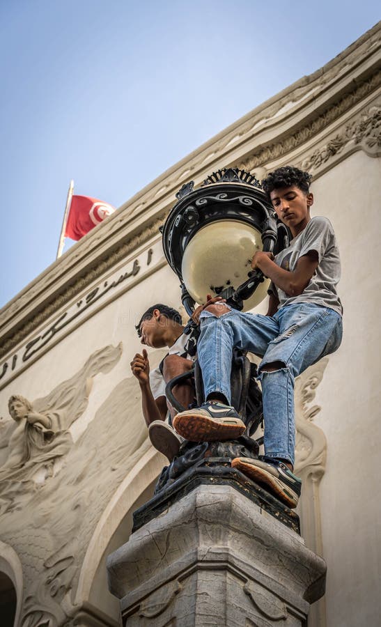 The boys on the street light (with the Tunisia flag on the background) during the pro-Palestine rally at Tunis downtown followed by the hospital blast in Gaza. The boys on the street light (with the Tunisia flag on the background) during the pro-Palestine rally at Tunis downtown followed by the hospital blast in Gaza.