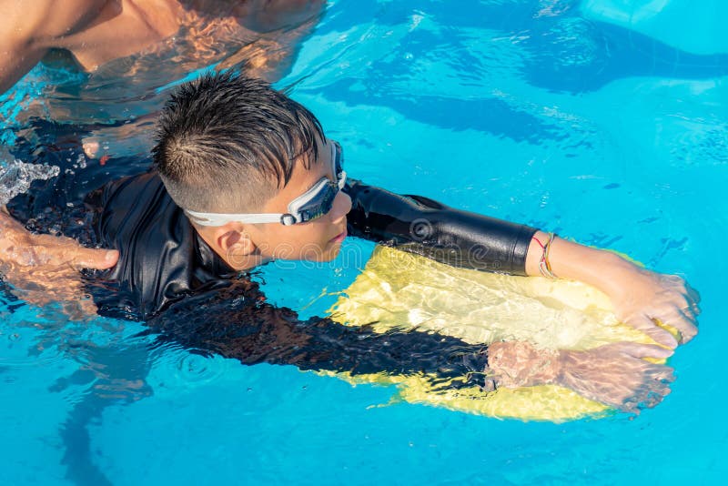 Boys are swimming in the pool