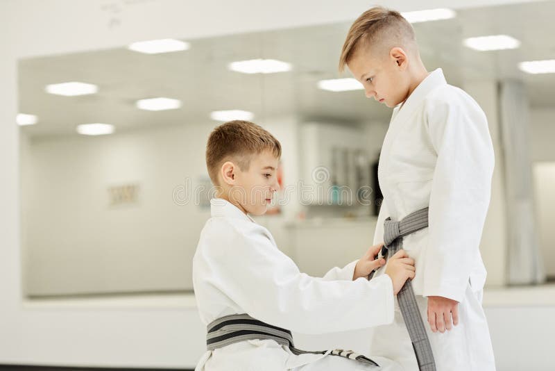 Boys tieing the belt on kimono