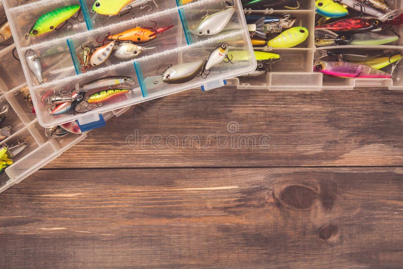 Fishing tackle boxes on wooden background with free space. Top view. Fishing tackle boxes on wooden background with free space. Top view.