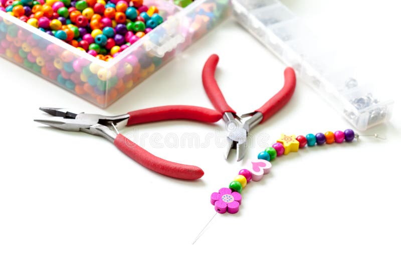Bracelet made of plastic beads for girls unfinished in process stock photos