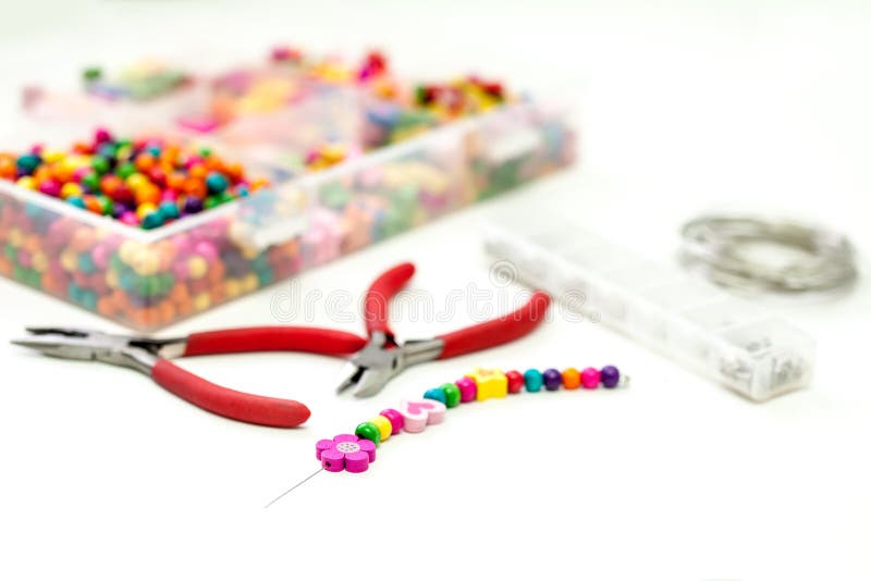 Bracelet made of plastic beads for girls unfinished in process stock photography