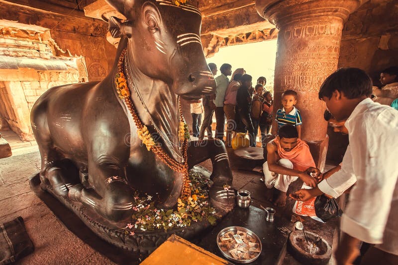 Brahman conducting a puja ritual inside the temple with the diety bull Nandi stock photos Brahman conducting a puja ritual inside the temple with the diety bull Nandi stock photos