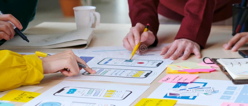 Brainstorm planing creative teamwork, Close up of hands mobile phone app developer team meeting about screen display prototype royalty free stock photo.