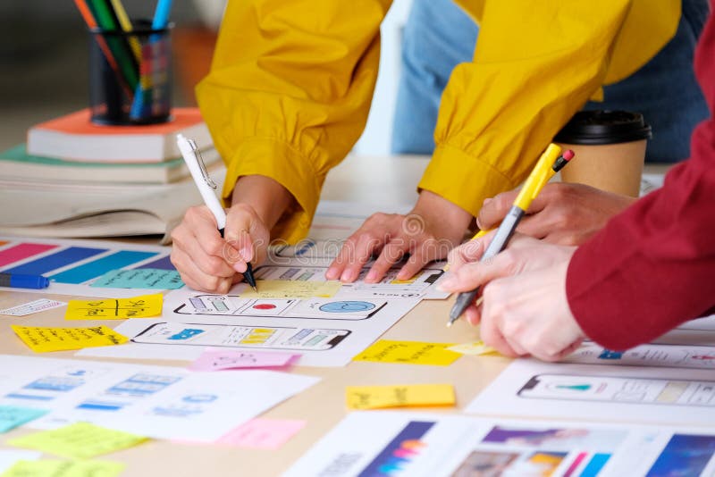 Brainstorm planing creative teamwork, Close up of hands mobile phone app developer team meeting about screen display prototype stock photo