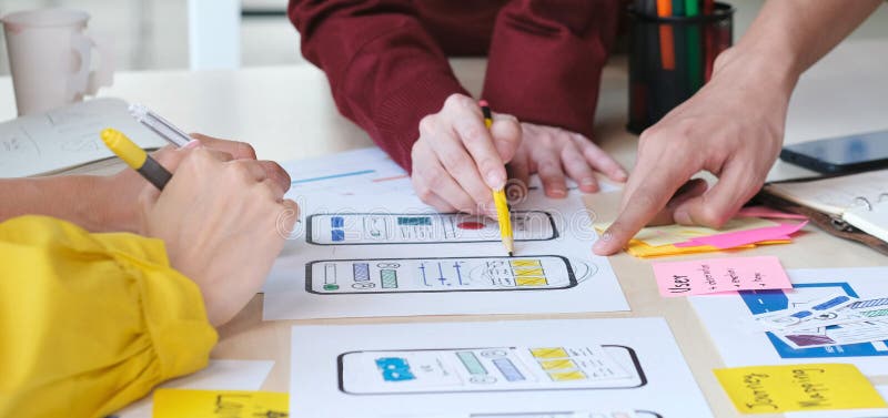 Brainstorm planing creative teamwork, Close up of hands mobile phone app developer team meeting about screen display prototype stock photography