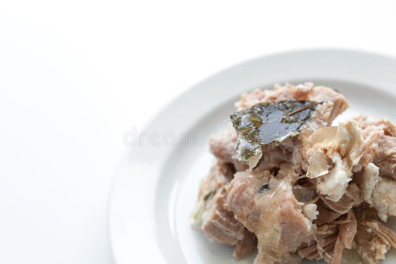 Braised Pork on a White Plate with Bay Leaves, White Background Stock