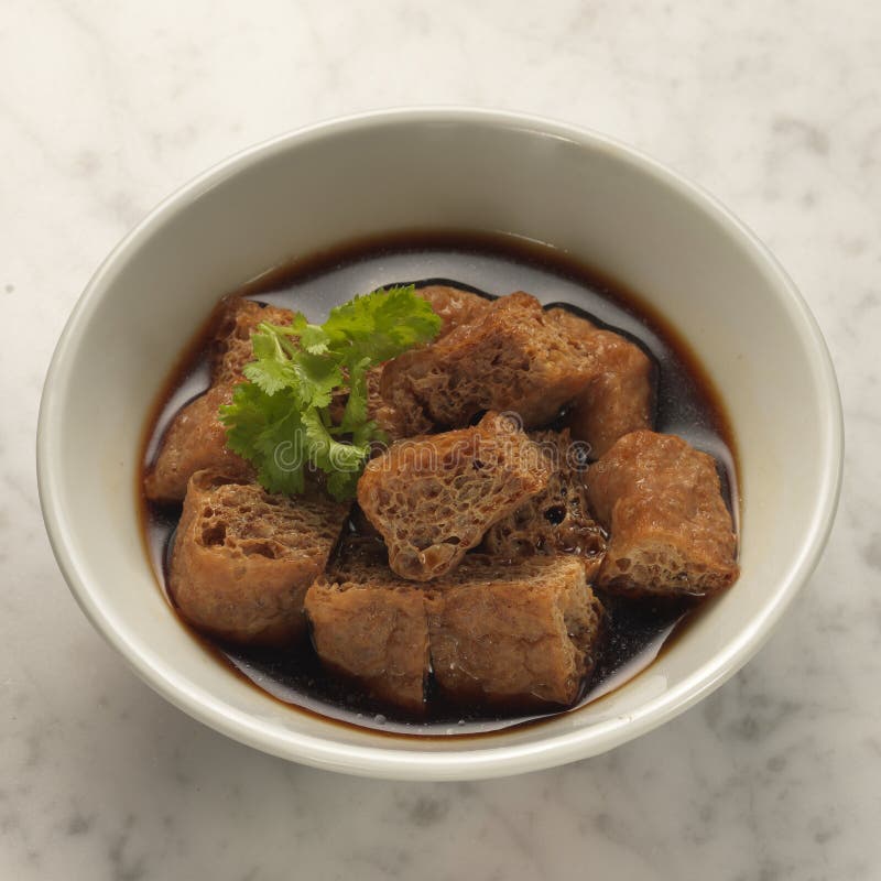 Braised puffed tofu. Traditional puffed tofu braised in soya sauce side dish in singapore and malaysia for bak kut teh, pork rib soup stock image Braised puffed tofu. Traditional puffed tofu braised in soya sauce side dish in singapore and malaysia for bak kut teh, pork rib soup stock image