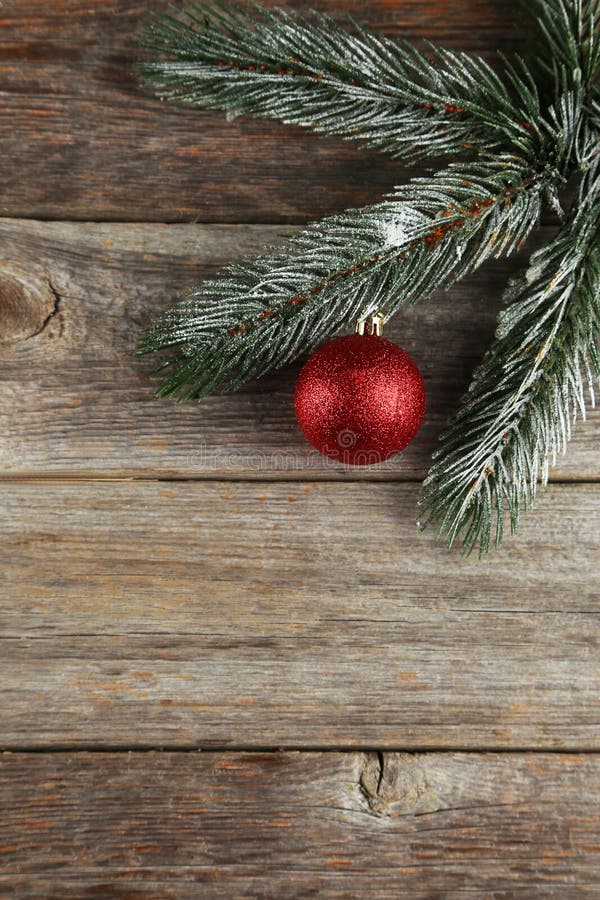 Branch Of Christmas Tree With Balls On Grey Wooden Background Stock