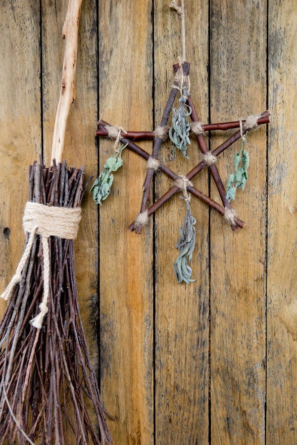 Branch Pentagram and Besom Witches Broom with dried herb bundles - Witchcraft tools of rustic natural wood. Branch Pentagram and Besom Witches Broom with dried herb bundles - Witchcraft tools of rustic natural wood