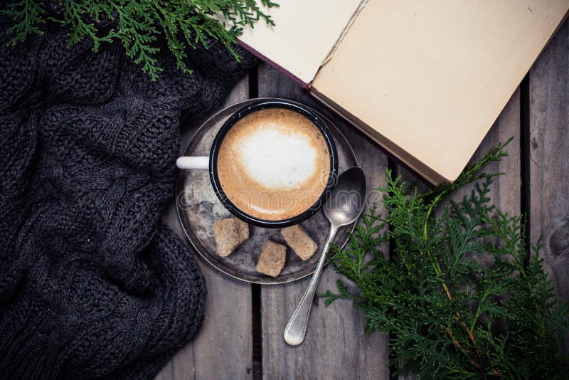 Branch of spruce, warm sweater and cup coffee with sugar