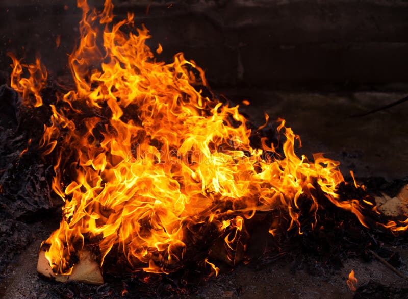 Fire and flames with a burning dark red-orange background. Fire and flames with a burning dark red-orange background