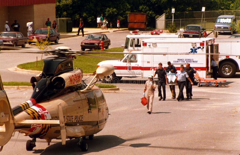 Brandmän och läkare bär en sårad person till en väntande helikopter arkivfoton Brandmän och läkare bär en sårad person till en väntande helikopter arkivfoton