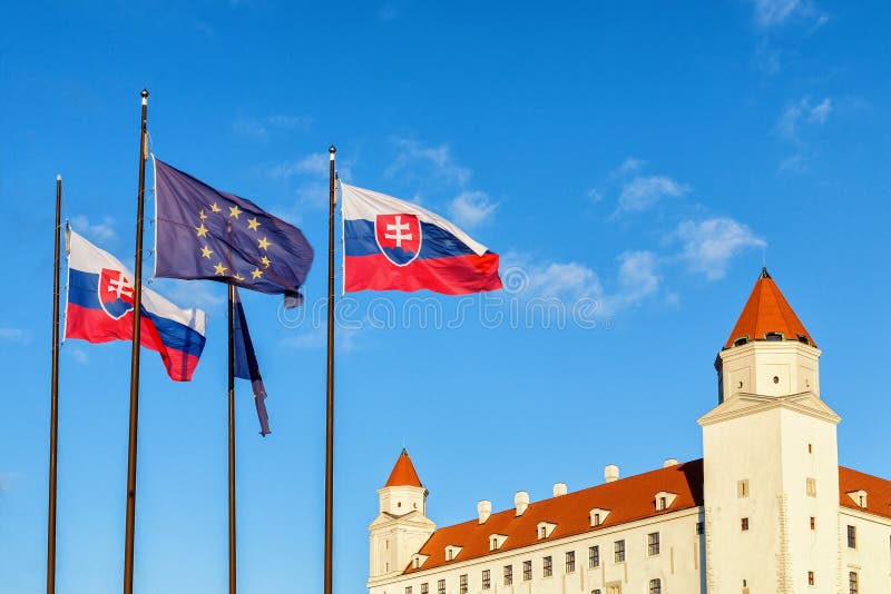 Bratislava castle and flags of Slovak republic and European Union