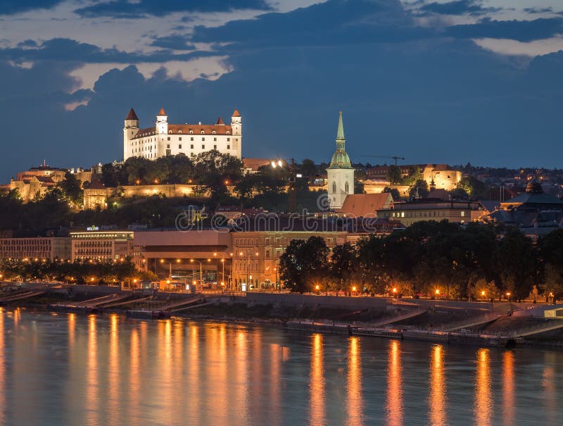 Bratislava castle at night with light reflection on the dunaj ri