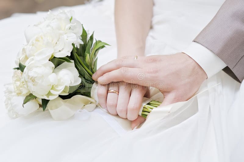 Bride and groom's hands with wedding rings. Bride and groom's hands with wedding rings