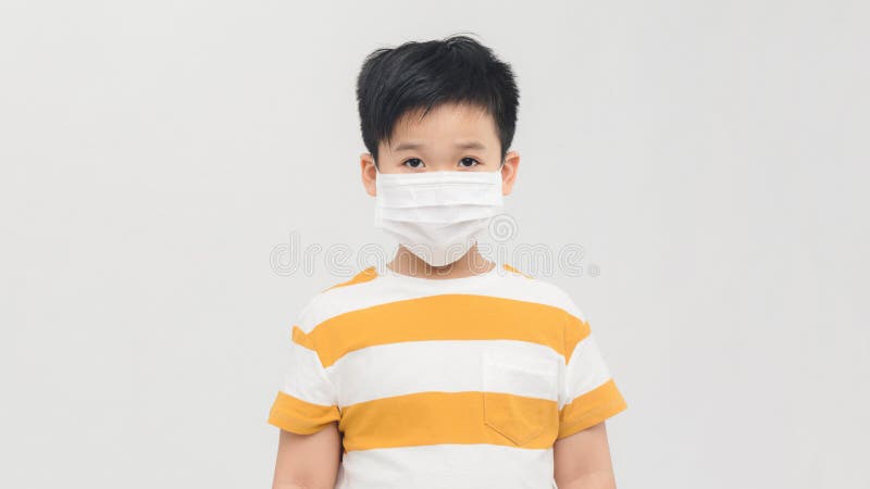 Brave teen boy with medical mask standing with courageous face  isolated on white. Childhood, stylish kids, fighting covid-19